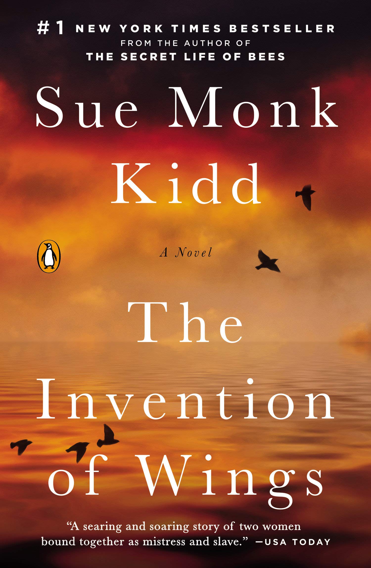 The Invention of Wings book cover done in oranges of calm water and a cloudy sky with the shadows of a few black birds flying around