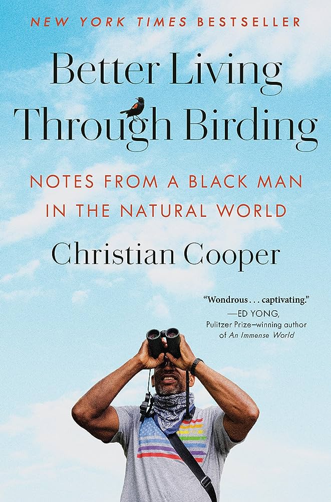 Better Living Through Birding by Christian Cooper book cover with the author standing in front of a sky background holding binoculars and looking up.