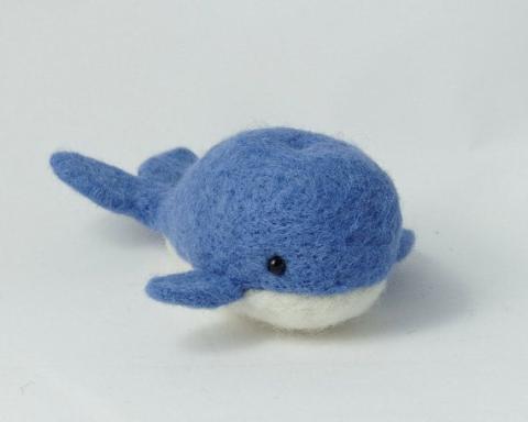 Picture is of a felt whale with blue on the top and white on the bottom 